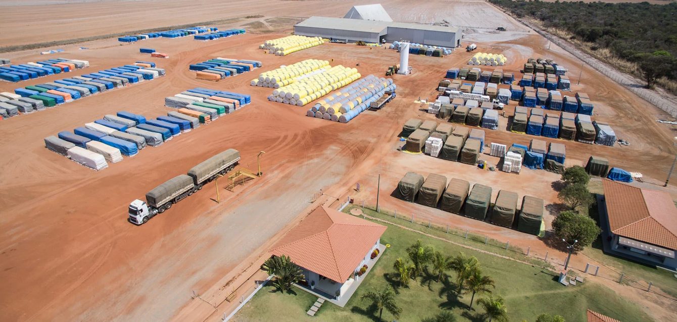 Pátio de algodoeira com rolos de algodão aguardando beneficiamento